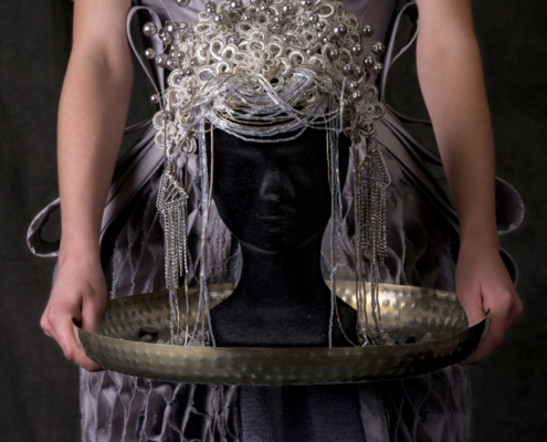 Grey dress with silver corset and silver headpiece symbolism - Fashion still life Ruud van Ooij