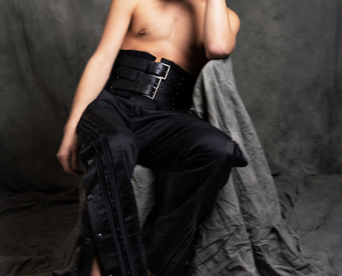 Skip Ros wearing a black corset belt and black twisted trousers Venus inspired modern masculinity - Ruud van Ooij fashion photography